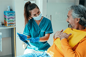 A dentist showing a patient their dental X-ray