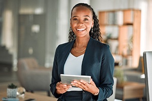 smiling businesswoman holding a tablet