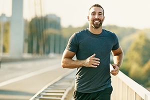 a man jogging on a bridge