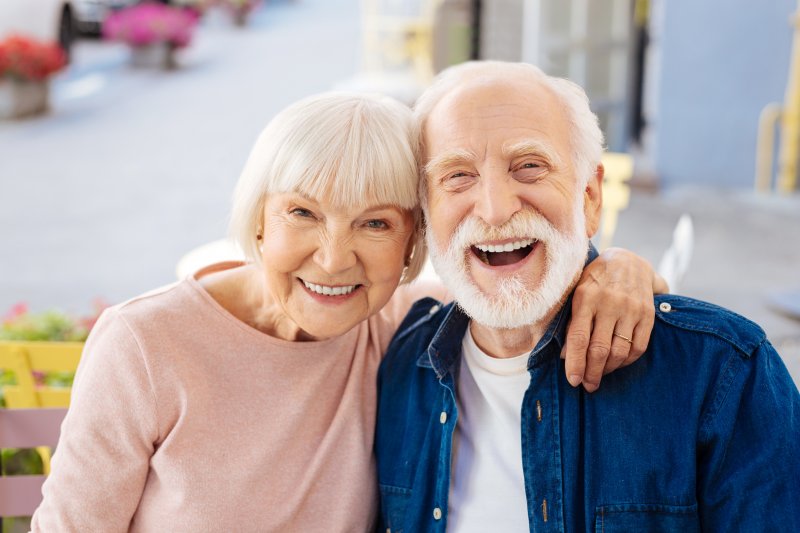 older couple smiling with dental implants 